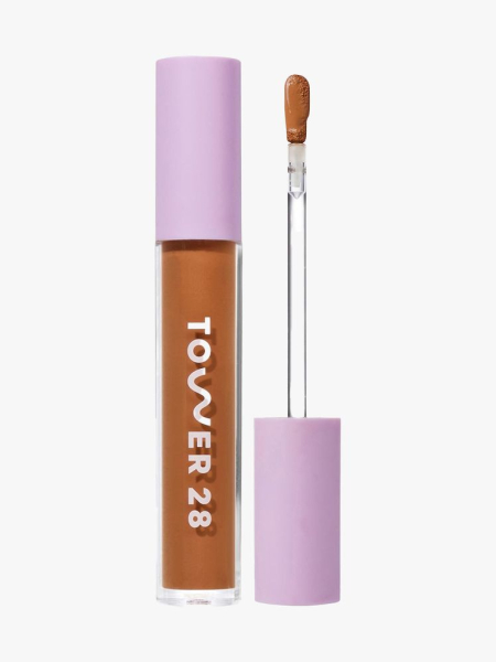 Tower 28 Swipe Serum Concealer vial of concealer with lilac cap and wand on light gray background