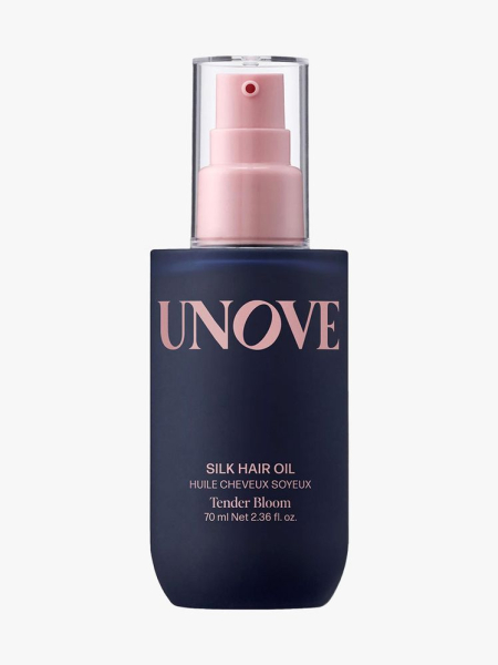 Navy blue bottle of Unove Silk Shine Hair Oil with clear cap on light gray background